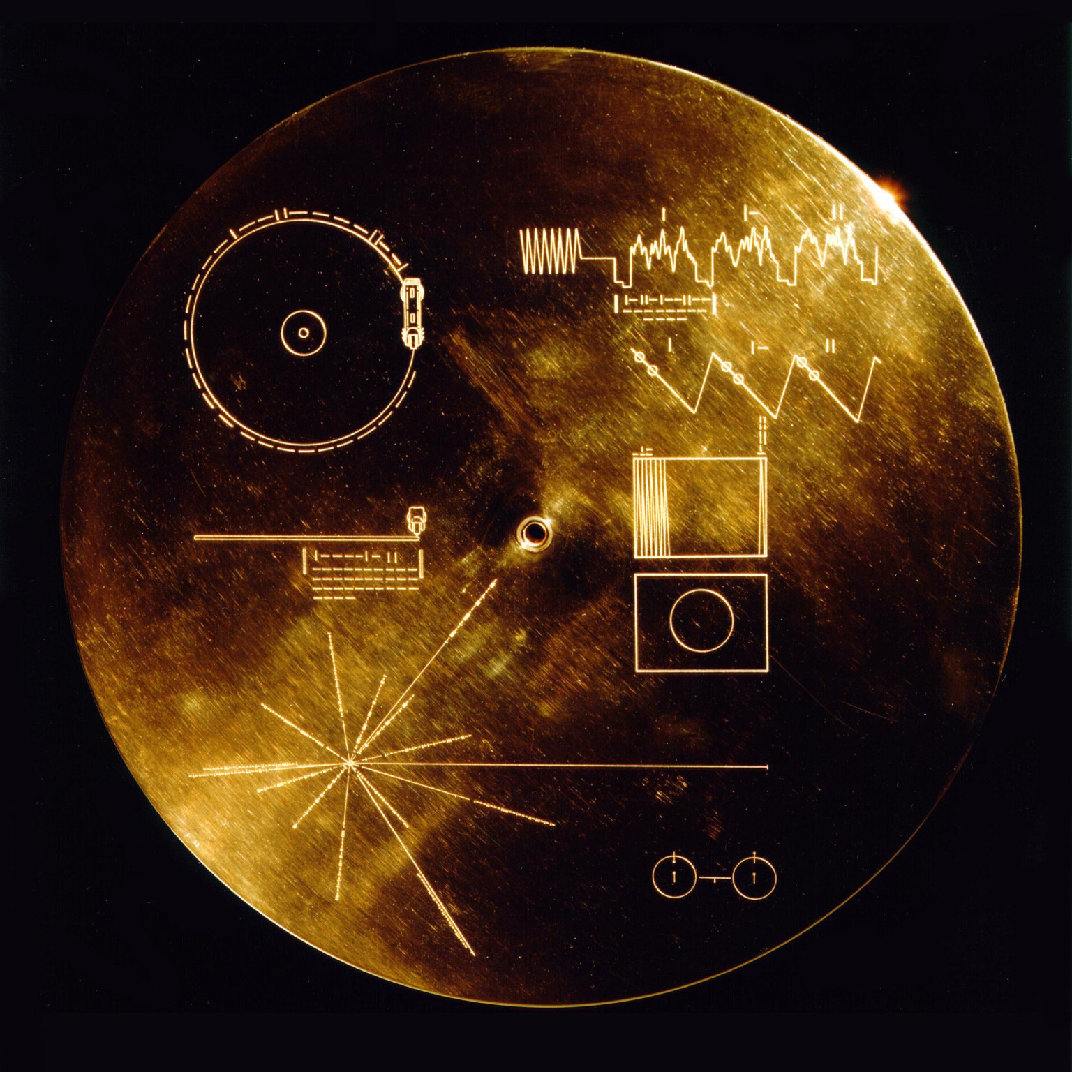 The Voyager record cover, showing the playback diagram, image instructions, pulsar map and hydrogen reference.